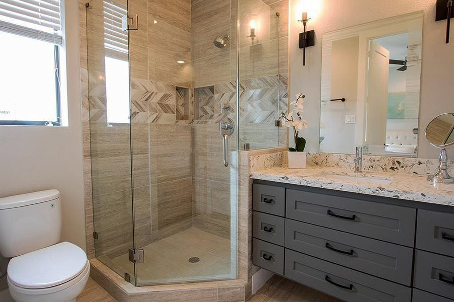 bathroom with glass enclosure stand up shower and marble top vanity with shaker style drawers