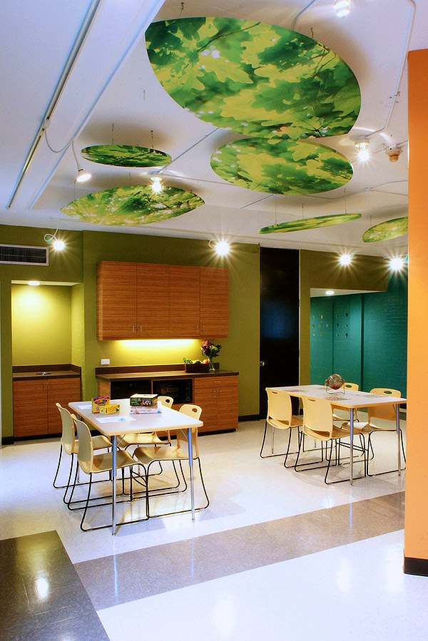 cafe area in a commercial space with ambient lighting and foliage looking ceiling lights