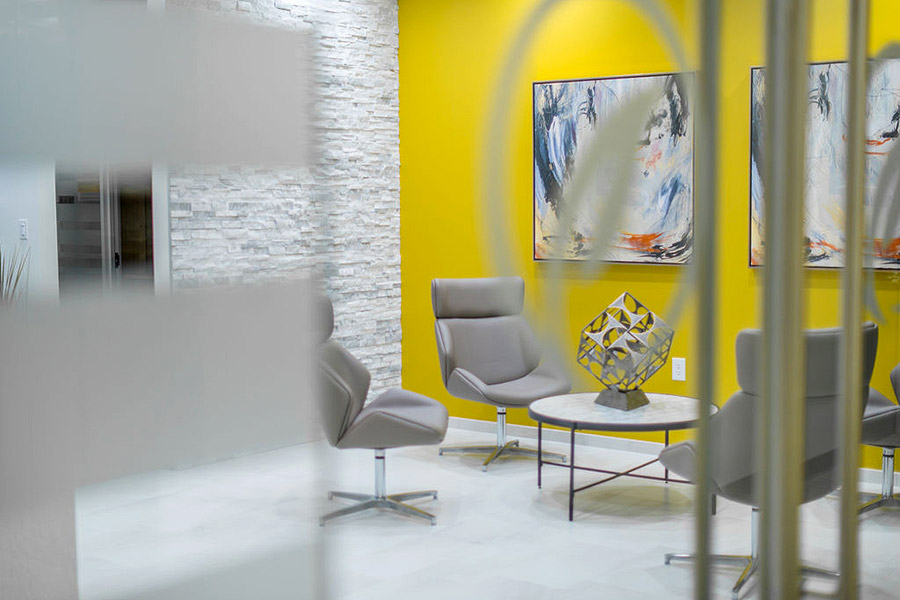 Office lobby with modern decor and yellow wall